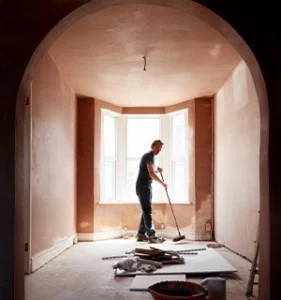 Man sweeping after building renovation