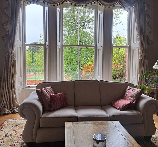 Interior image of sofa in front of Fineo glass windows